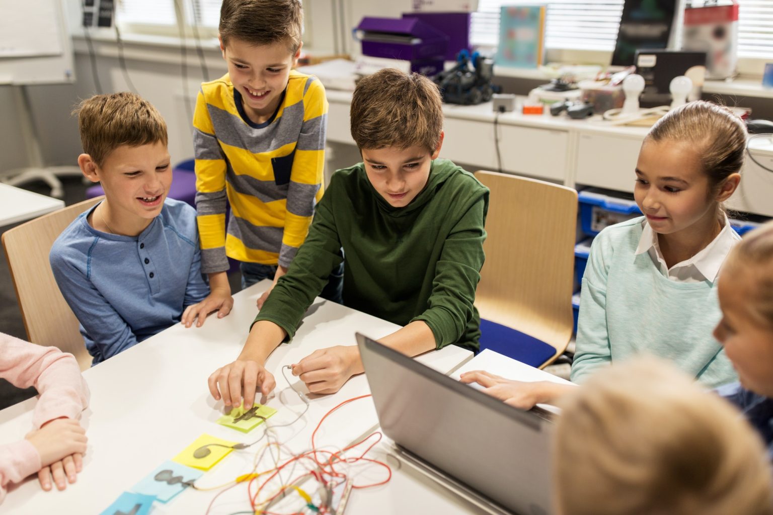 kids, laptop and invention kit at robotics school