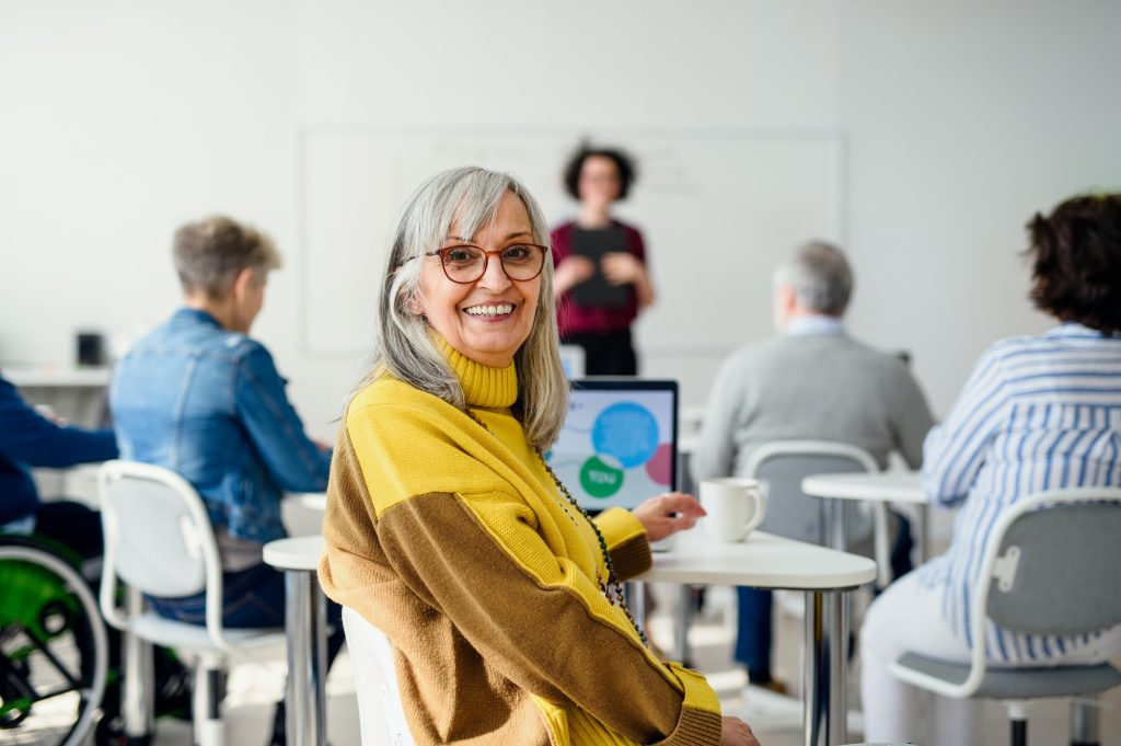 Portrait of senior attending computer and technology education class