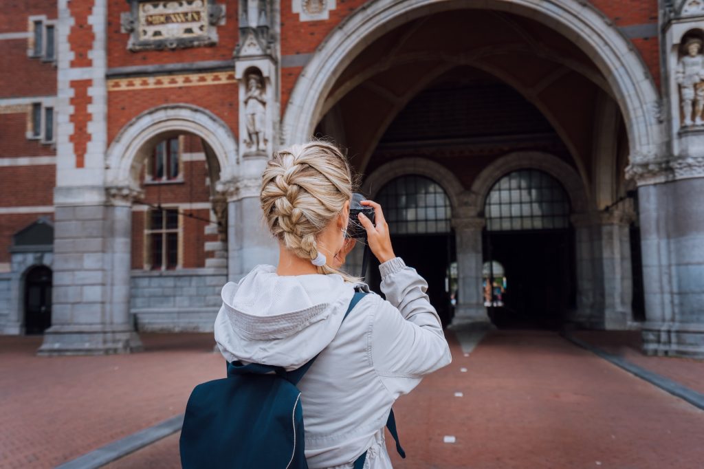 Woman tourist visiting museum in Amsterdam. Travel in Europe city trip concept